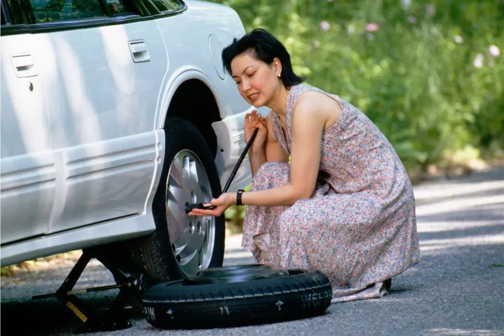 Lady Changing Flat Tire